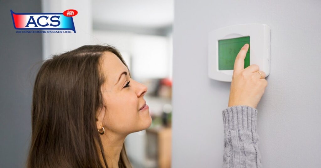 woman checking thermostat