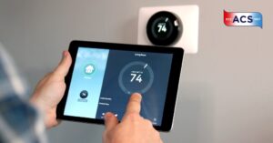 closeup of person programming thermostat using smart tablet