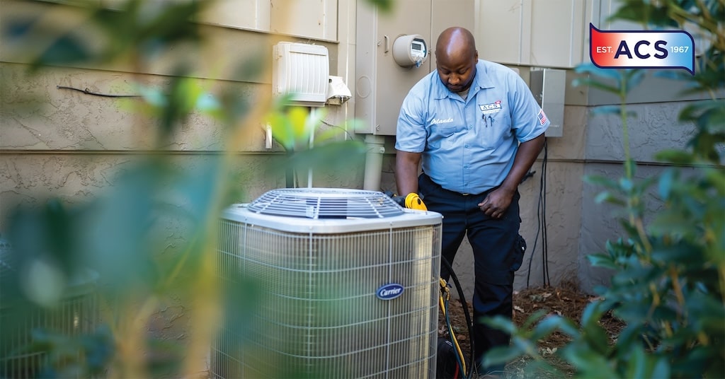 HVAC repairman looking at an outside HVAC unit